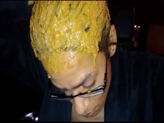 A pervert man gathers his feces and places them on his head.